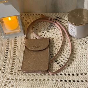 Kate Spade New York Stylish metallic Rose Gold Crossbody purse.